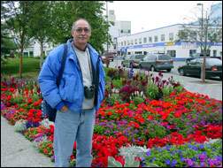 Rick standing in front of flowers outside