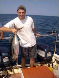 Dan holding a fish on the water